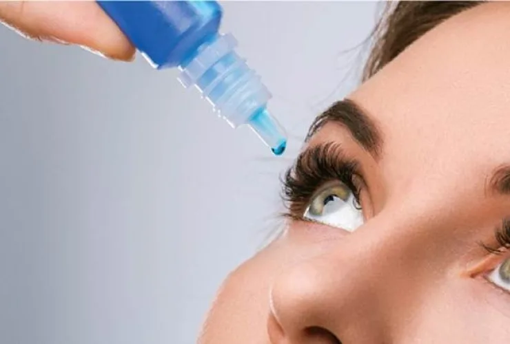 Pessoa aplicando colírio nos olhos